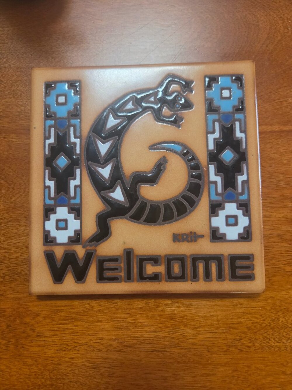 decorative ceramic welcome tile with a stylized gila monster southwestern design